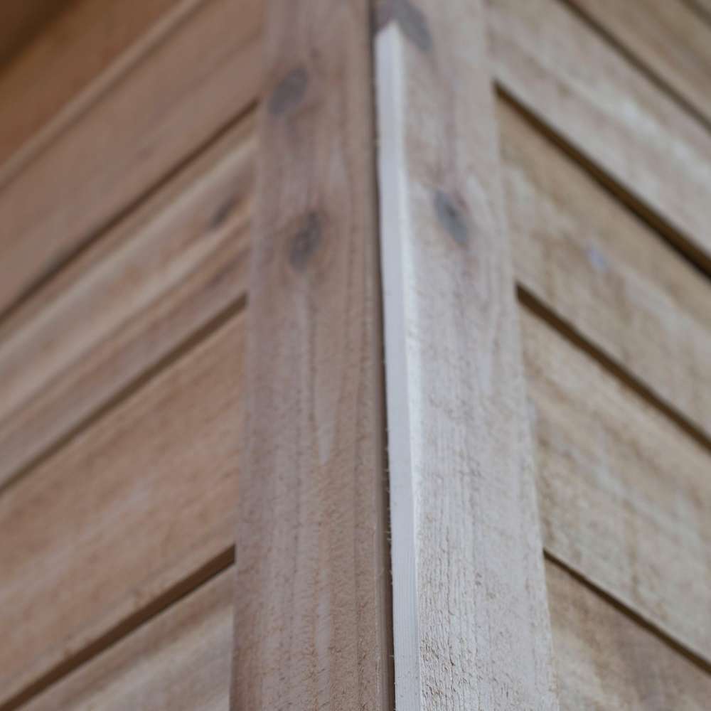 Outdoor Living Today 12×8 Saltbox Studio Outdoor Office is detailed in a close-up of the cedar wall corner showing smooth wood grain and panel alignment