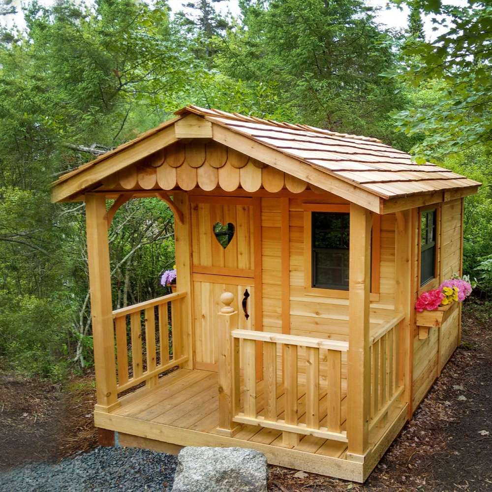 Outdoor Living Today 6x9 Sunflower Playhouse & Sandbox delivers a cozy cedar playhouse with a covered porch, heart-shaped door, and flower box accents