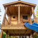 Outdoor Living Today 6x9 Sunflower Playhouse & Sandbox highlights a close-up of the cedar porch, heart-cutout door, and blue slide from below