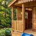 Outdoor Living Today 6x9 Sunflower Playhouse & Sandbox showcases the front porch detail with cedar railings, open doorway, and partial view of the slide