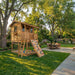 Outdoor Living Today 7x9 Cozy Cabin Signature Cedar Playhouse & Sandbox with porch, ladder access, climbing wall, and open play space below