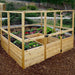 Outdoor Living Today 8×8 Raised Garden Bed is fully enclosed with a wooden and wire fence, containing thriving vegetables and flowers
