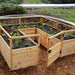 Outdoor Living Today 8×8 Raised Garden Bed is shown with an open gate and freshly planted vegetables and flowers inside its wooden frame
