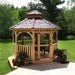 Outdoor Living Today Western Red Cedar Octagon Bayside Gazebo features screened windows and a door, set on a wooden deck in a grassy backyard