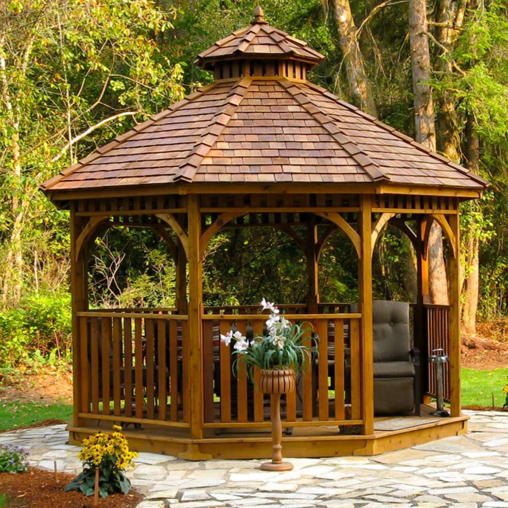 Outdoor Living Today Western Red Cedar Octagon Bayside Gazebo sits on a stone patio surrounded by trees