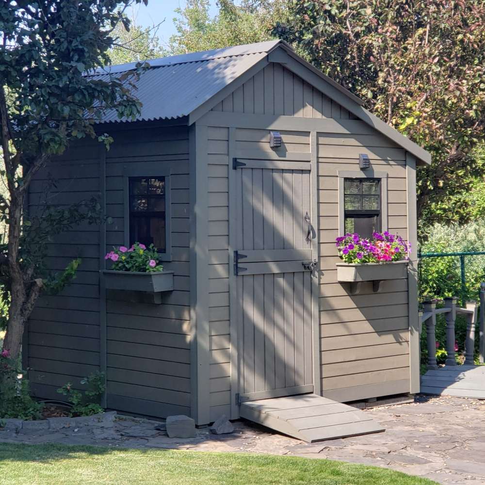 Outdoor Living Today Western Red Cedar Shed Ramp is installed at the entrance of a gray garden shed
