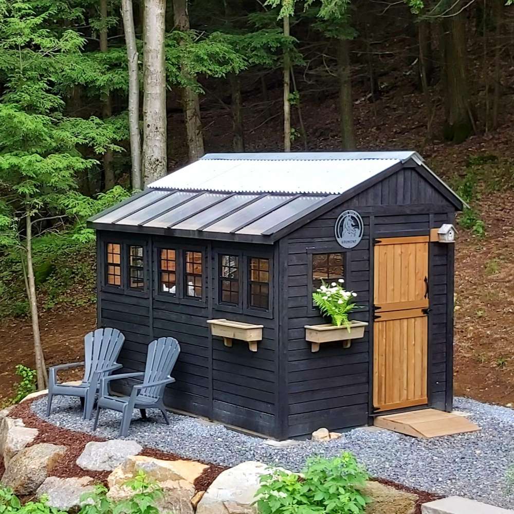Outdoor Living Today Western Red Cedar Shed Ramp is used with a black shed in a landscaped yard