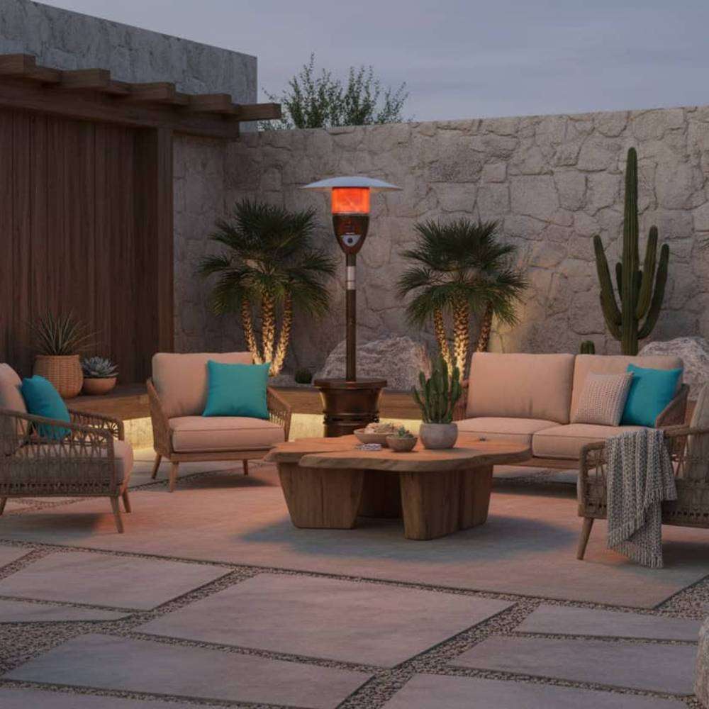 Outdoor Order Halo Traditional Heater glows behind a cushioned sofa and lounge chairs in a desert courtyard with cactus plants