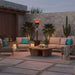 Outdoor Order Halo Traditional Heater glows behind a cushioned sofa and lounge chairs in a desert courtyard with cactus plants