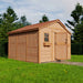Outdoor Living Today 12×12 Sunshed Garden Shed stands on bright grass with a half-open wooden door and a small window box on its side