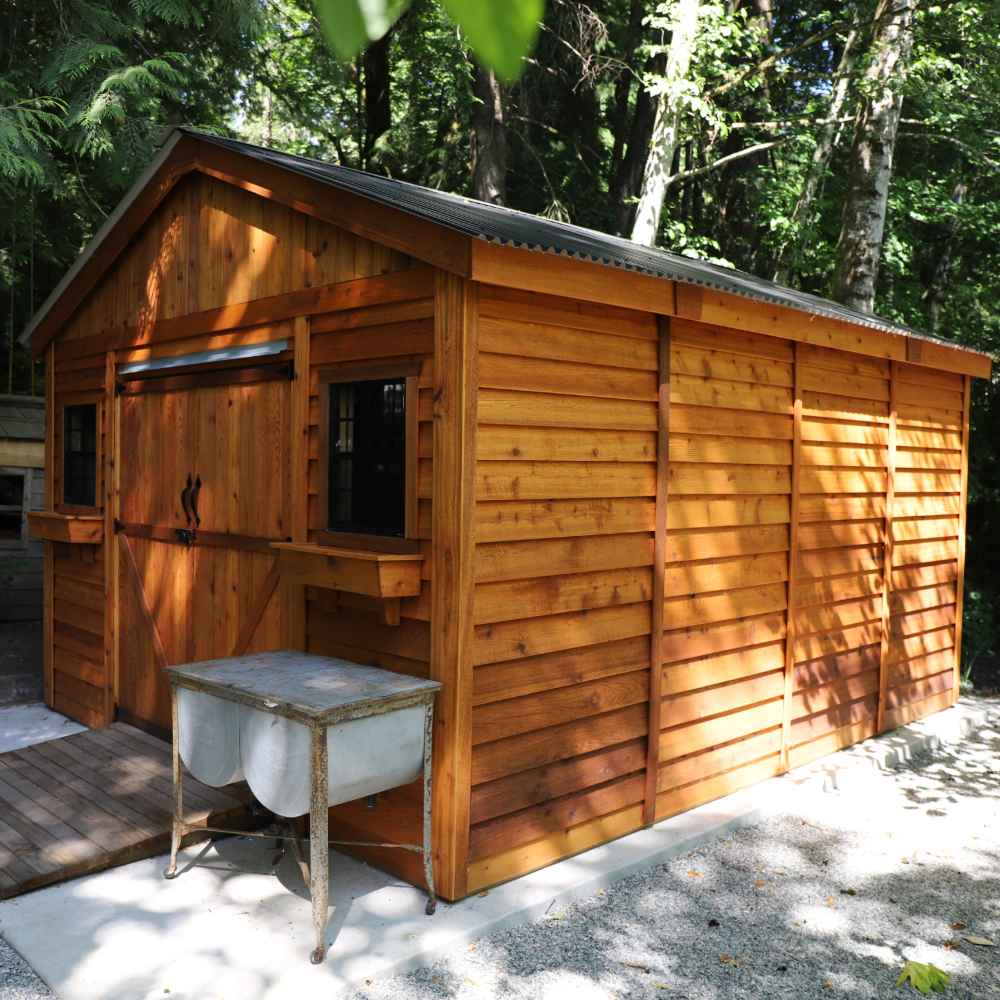 Outdoor Living Today 12×16 Double Door Space Master Storage Shed features a long, side-panel design with beautiful cedar siding and a metal roof