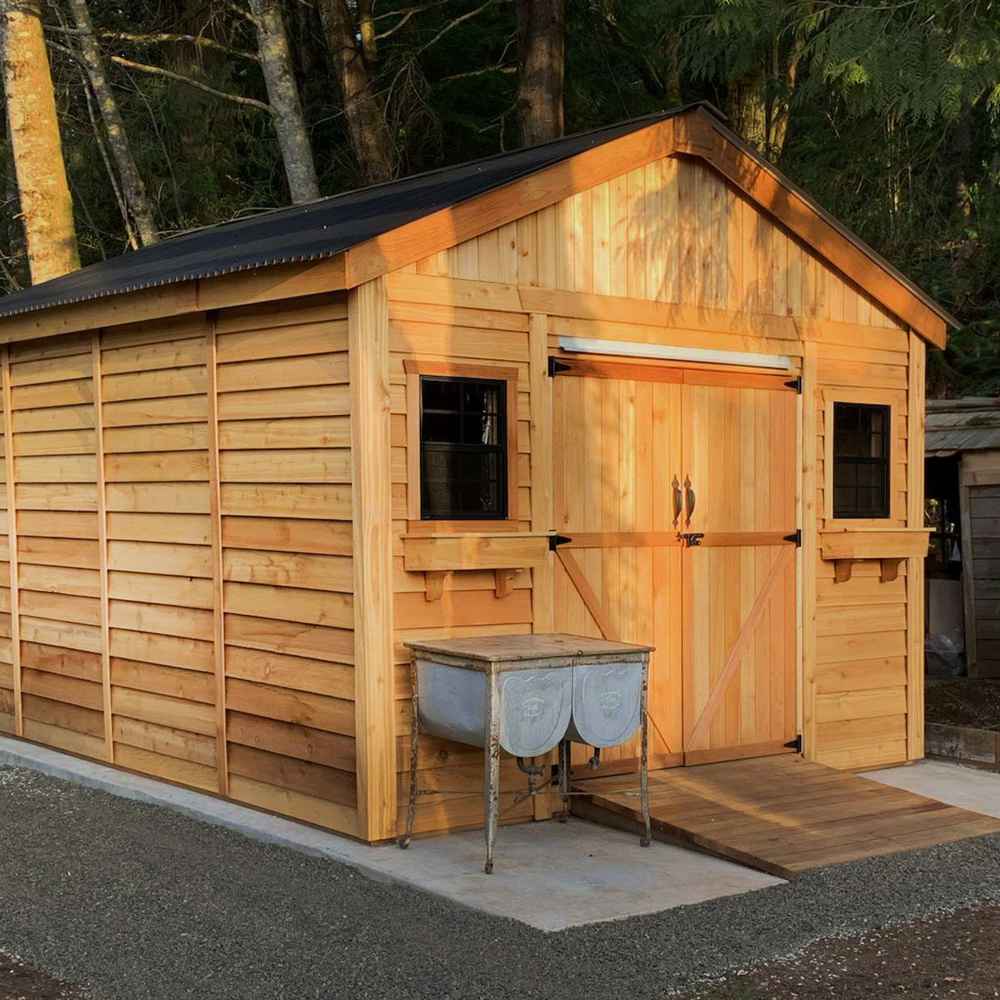 Outdoor Living Today 12×16 Double Door Space Master Storage Shed glows warmly in the sunlight