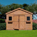 Outdoor Living Today 12×16 Double Door Space Master Storage Shed stands front-facing on a lawn with both doors closed