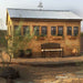 Outdoor Living Today 12×16 Sunshed Garden Shed from the side, showcasing multiple windows, flower boxes, and a bench on a stone patioOutdoor Living Today 12×16 Sunshed Garden Shed from the side, showcasing multiple windows, flower boxes, and a bench on a stone patio