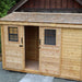 Outdoor Living Today 12×4 with Sliding Doors SpaceSaver Storage Shed is shown with one sliding door open