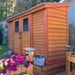 Outdoor Living Today 12×4 with Sliding Doors SpaceSaver Storage Shed stands beautifully in a garden