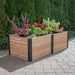 Outdoor Living Today 6×3 Urban Raised Garden Bed is fully planted with vibrant red, yellow, and purple flowers in a sunlit backyard