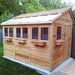 Outdoor Living Today 8×12 Sunshed Garden Shed is shown from the side, with natural cedar wood siding and black-trimmed windows under a bright roof