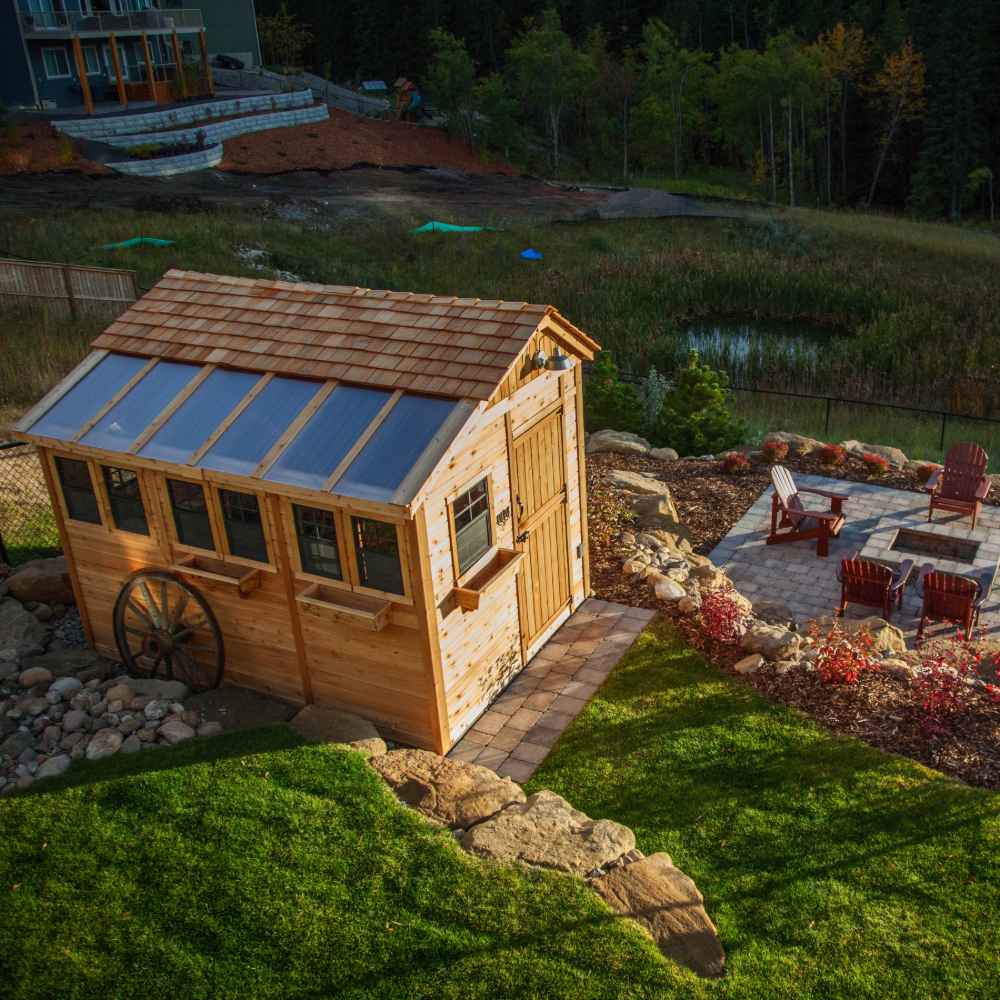 Outdoor Living Today 8×12 Sunshed Garden Shed stands near a fire pit and chairs on a stone patio