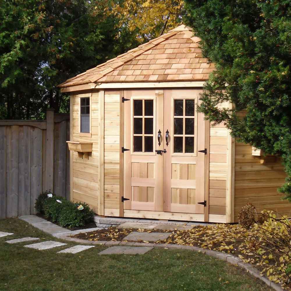 Outdoor Living Today 9×9 Penthouse Garden Shed sits tucked in a leafy backyard corner, surrounded by a wooden fence
