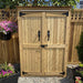 Outdoor Living Today Garden Chalet is a wooden storage shed with stylish black metal hinges and handles, surrounded by greenery and flowers