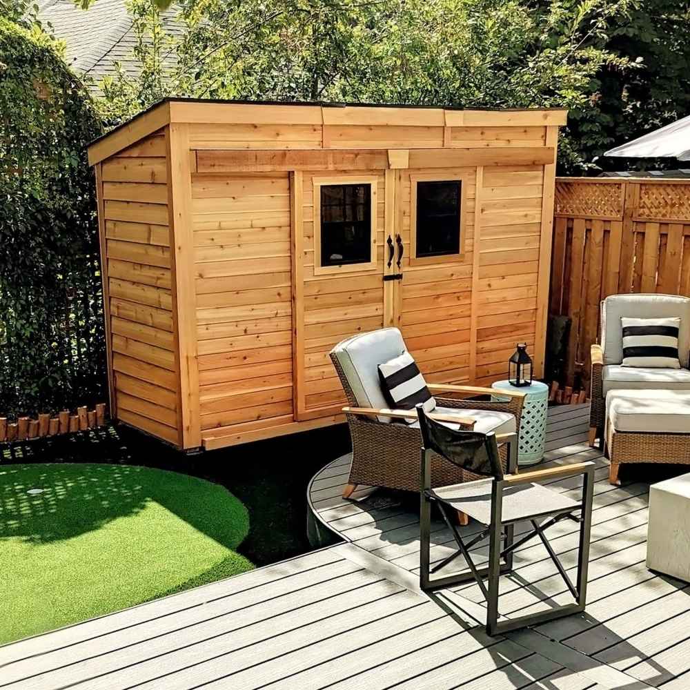 Outdoor Living Today GardenSaver 12×4 with Sliding Doors is placed next to a cozy patio with outdoor chairs and a table