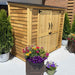 Outdoor Living Today Grand Garden Chalet with metal roof is shown from an angle, highlighting its horizontal wood slats and dual front doors