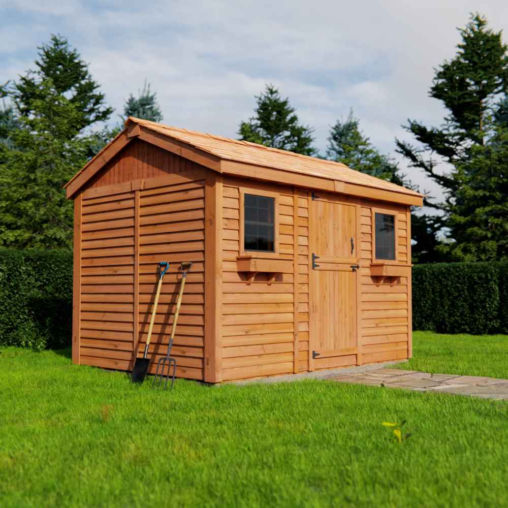 Outdoor Living Today Large 12×8 Cabana Garden Shed sits on a grassy lawn with a closed wooden door, two small windows, and garden tools leaning against the side