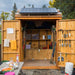 Outdoor Living Today Maximizer 6×6 Wooden Shed’s double doors are fully open, displaying organized shelves, tools, and a solar panel installed on the roof