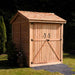 Outdoor Living Today Maximizer 6×6 Wooden Shed is pictured from the front corner, showing its solid wood construction and neatly finished shingle roof