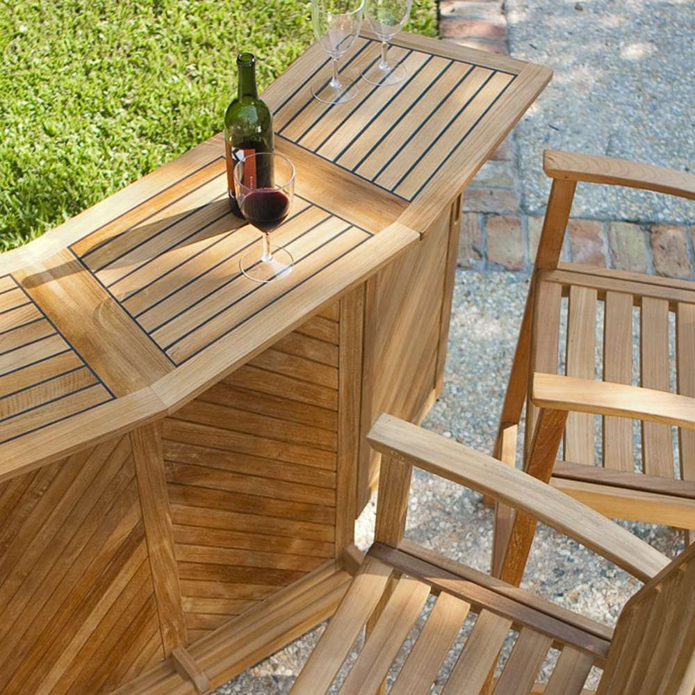 Overhead outdoor view shows the bar table from Westminster Teak Somerset 5pc Teak High Bar Set with a wine bottle and glasses on top beside teak stools