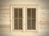 Pair of rectangular wooden windows with grid-pane glass panels on the exterior of the Sawmill Structures Harvest Grand Bungalow 107 Garden Room