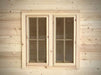 Pair of rectangular wooden windows with grid-pane glass panels on the exterior of the Sawmill Structures Harvest Grand Bungalow 107 Garden Room