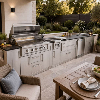 Patio scene featuring the Sunstone French Quarter 13ft 7in Outdoor Kitchen Island Package with grill, prep space, and storage near a dining table