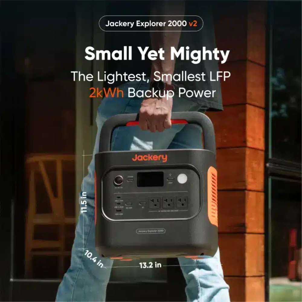 Person carries Jackery Explorer 2000 V2 Portable Power Station by its handle, highlighting its compact size and portable 2kWh backup power design