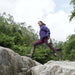 Person carries Jackery Explorer 300D Portable Power Station while walking across large rocks outdoors