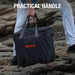 Person carries Jackery Upgraded Carrying Case Bag (L) across rocky terrain using the sturdy dual handles