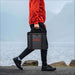 Person carries Jackery Upgraded Carrying Case Bag (S) by its padded handle while walking outdoors