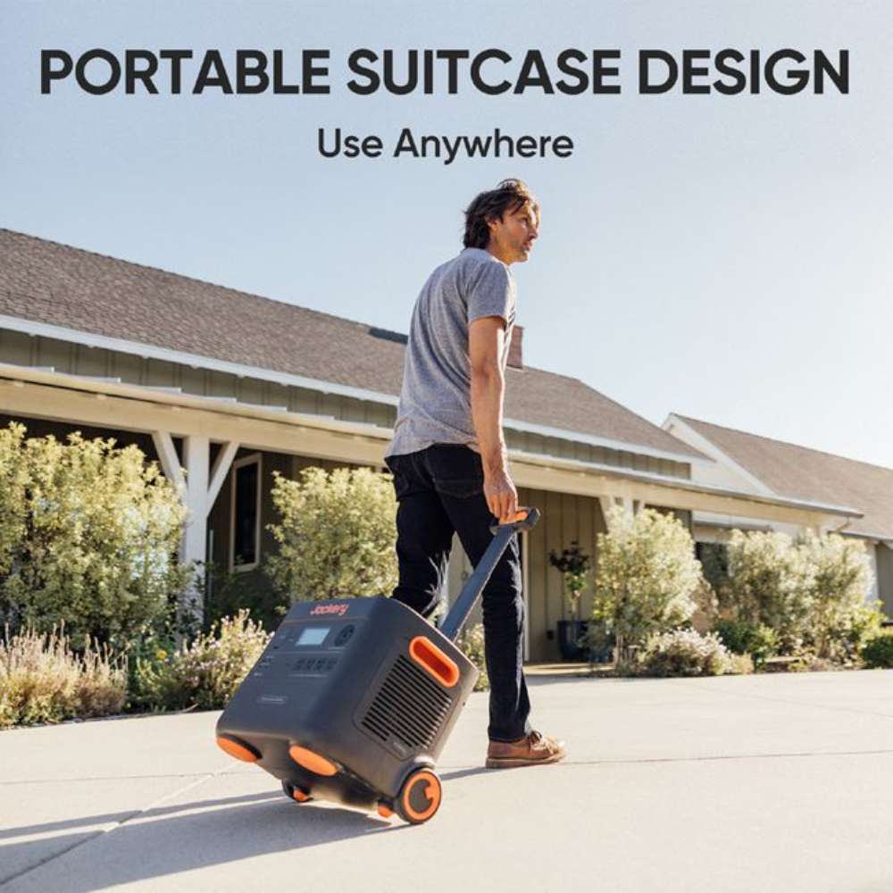 Person pulls Jackery Explorer 2000 Plus Portable Power Station by its telescoping handle, showing its portable suitcase-style design