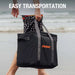 Person walks along the beach carrying Jackery Upgraded Carrying Case Bag (L) with its comfortable carry handles