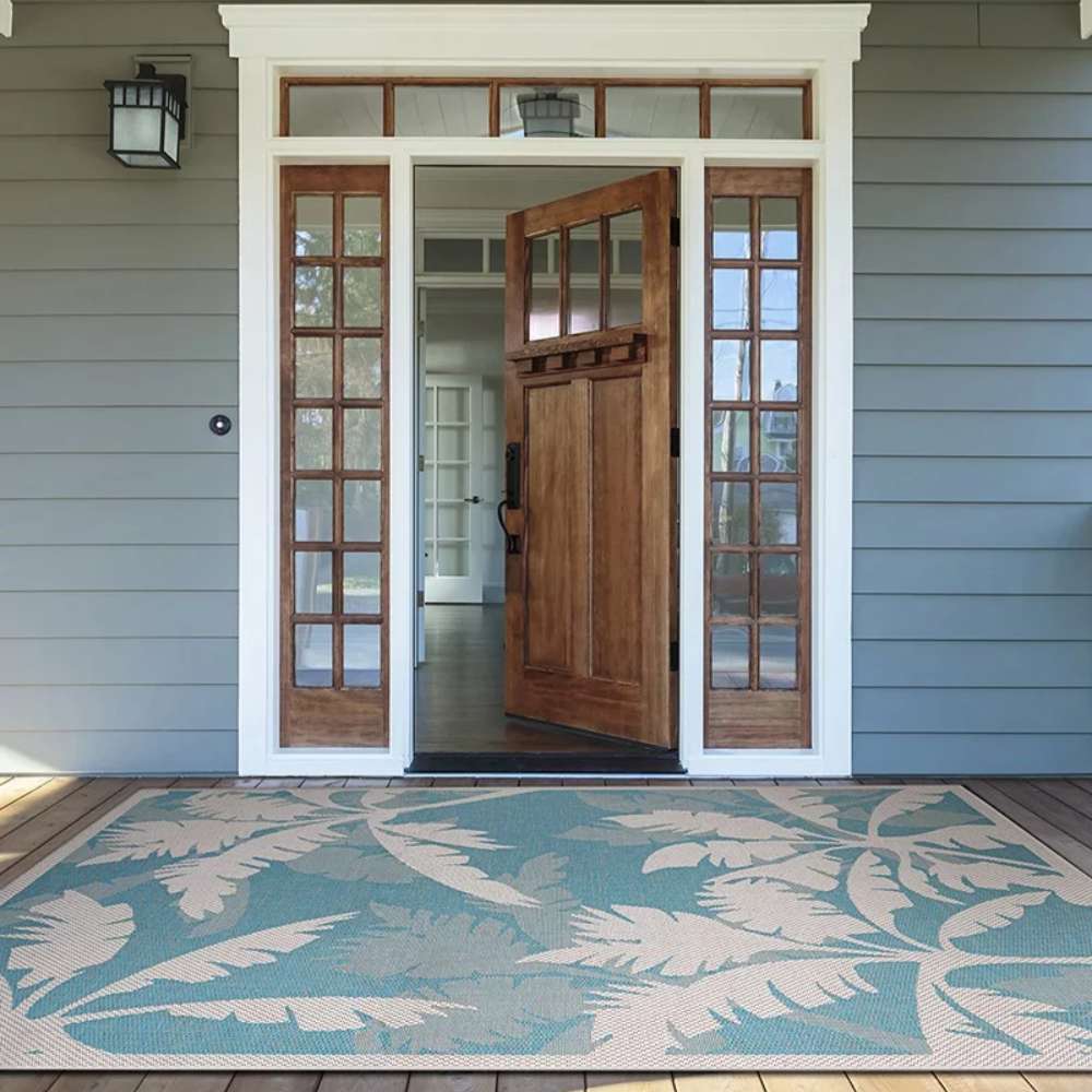 Placed at a front entryway, Couristan Monaco Indoor/Outdoor Rug - Coastal Flora/Ivory-Turquoise adds tropical style to the home