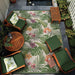 Placed in a cozy patio setup, Couristan Dolce Indoor/Outdoor Rug - Flowering Fern/Ivory-Hunter Green ties together wooden furniture and greenery