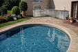 Poolside patio featuring Sunstone Rancher L-Shaped 8′11″ × 11′ Outdoor Kitchen Package near a curved pool and garden