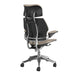 Rear angled view of Crate & Barrel Humanscale® Freedom Headrest Natural Linen Office Chair showing the black back frame and chrome supports