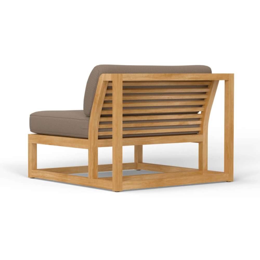 Rear angled view of Westminster Teak Maya Slipper Chair shows its sturdy teak frame and slatted back design