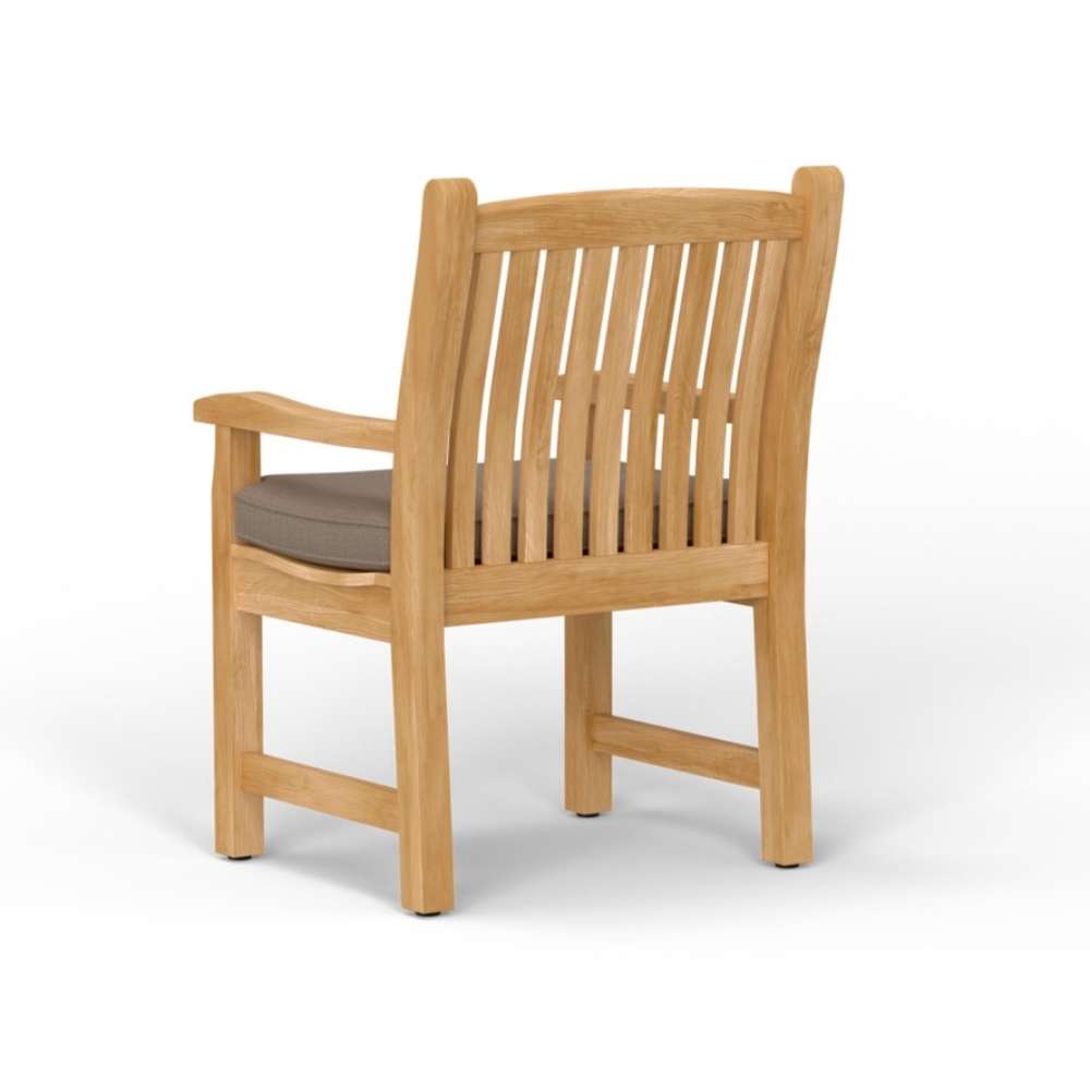 Rear angled view of Westminster Teak Veranda Teak Armchair highlights its curved slatted back and sturdy wooden frame