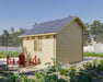 Rear-side view of the Sawmill Structures BlueWater Bungalow 160 Garden Room reveals a peaceful patio area surrounded by lush greenery