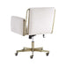 Rear view of Crate & Barrel Caterina Natural Upholstered Office Chair with Brass Base, showing its cream fabric upholstery, brass frame accents, and rolling caster base
