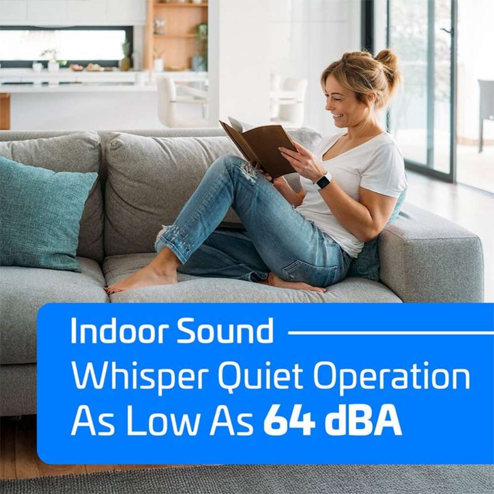 Relaxed woman reading a book on a gray sofa highlights the low indoor sound level of the ACiQ 24000 BTU Essentials 23 SEER2 2 Zone Wall Mount Mini Split Heat Pump System