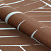 Rolled-up edge of Couristan Dolce Indoor/Outdoor Rug - Parquet/Amber displays its thick weave and abstract linear design